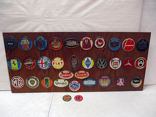 image of Wood Panel with Assorted Automotive Badges and Emblems